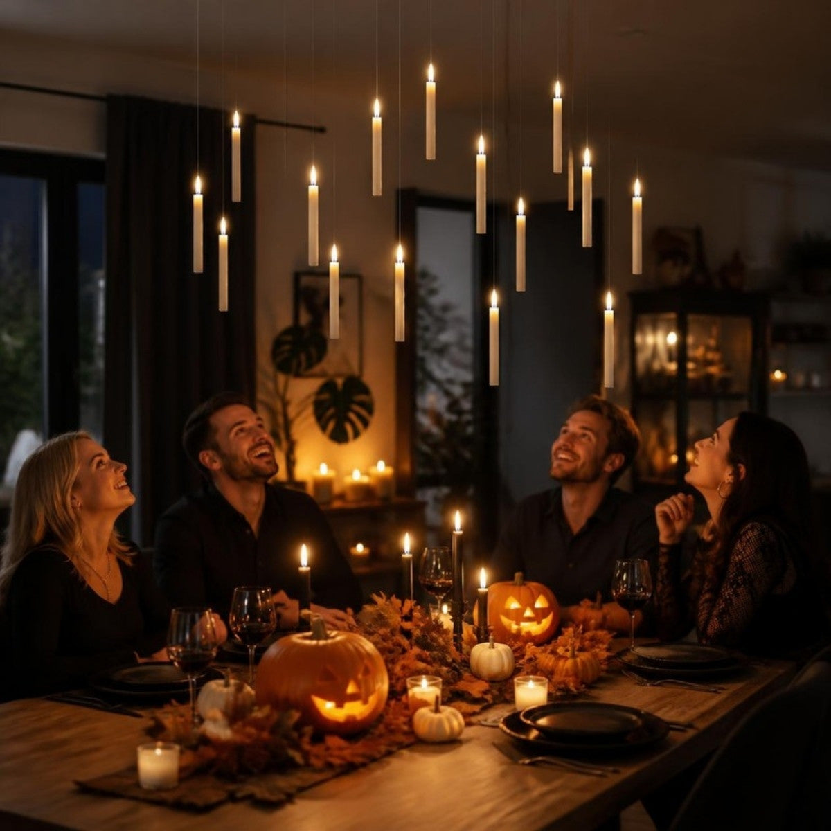 Friends at a Halloween dinner party looking up at floating LED candles